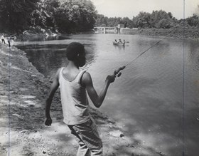 Boy fishing along the Conestoga River, LancasterHistory